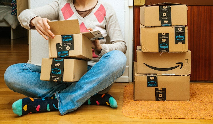 Amazon Prime members: customer opening a box from Amazon